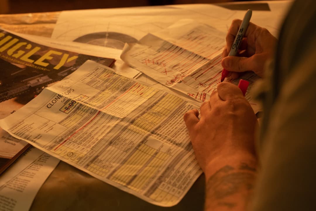 Behind the scenes photo 6 from Clone Cops production showing 1st ad nate eggert taking notes for the day